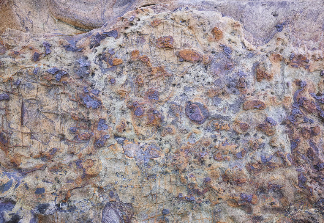 Sea Treasures | Colorful revealing small rocks embedded in a larger rock by the sea