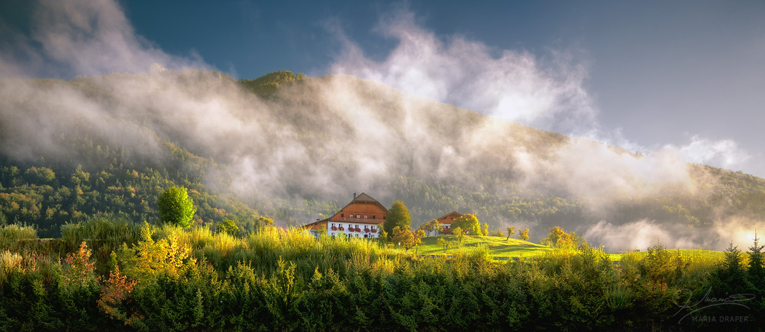 St Wolfgang, Austria | Farmhouse on top of a hill surrounded by a rising mist