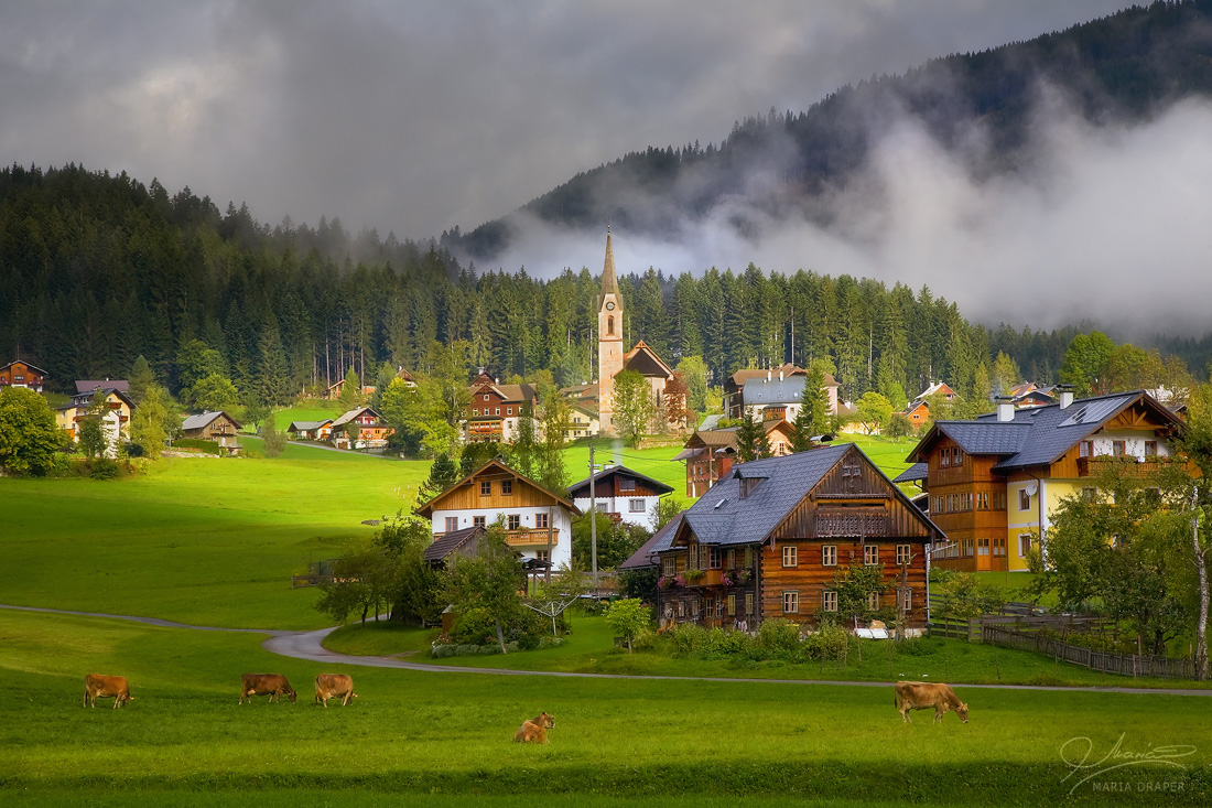 Gosau Village, Austria | Adorable, rustic, fairytale like village in Gosau, Salzkammergut region, not far from the famous Gosausee lake and Dachstein mountains, on the morning of a September day with low clouds and rising mist.